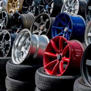 Car sport rims and tyres shown at tyre shop.